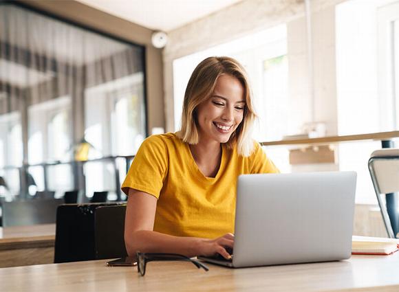 lady smiling at laptop in office