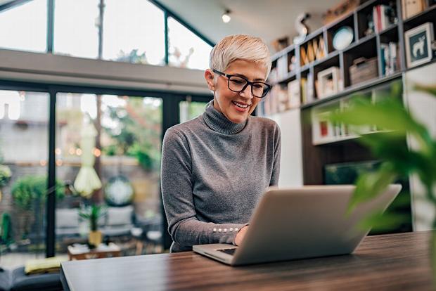 older lady working from home on laptop