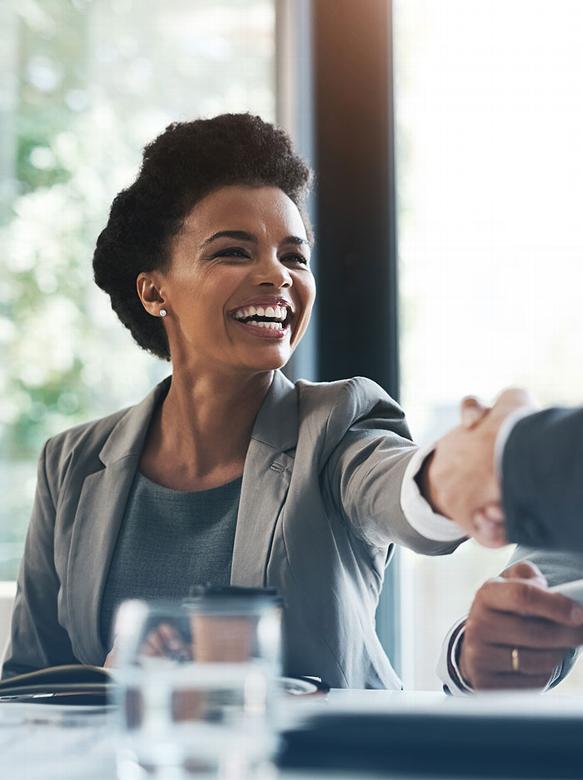 woman shaking mans hand in office